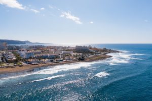 Aerial shot of Tenerife coastline near Las Americas. Beautiful landscape of Atlantic ocean with luxury hotels and restaurants